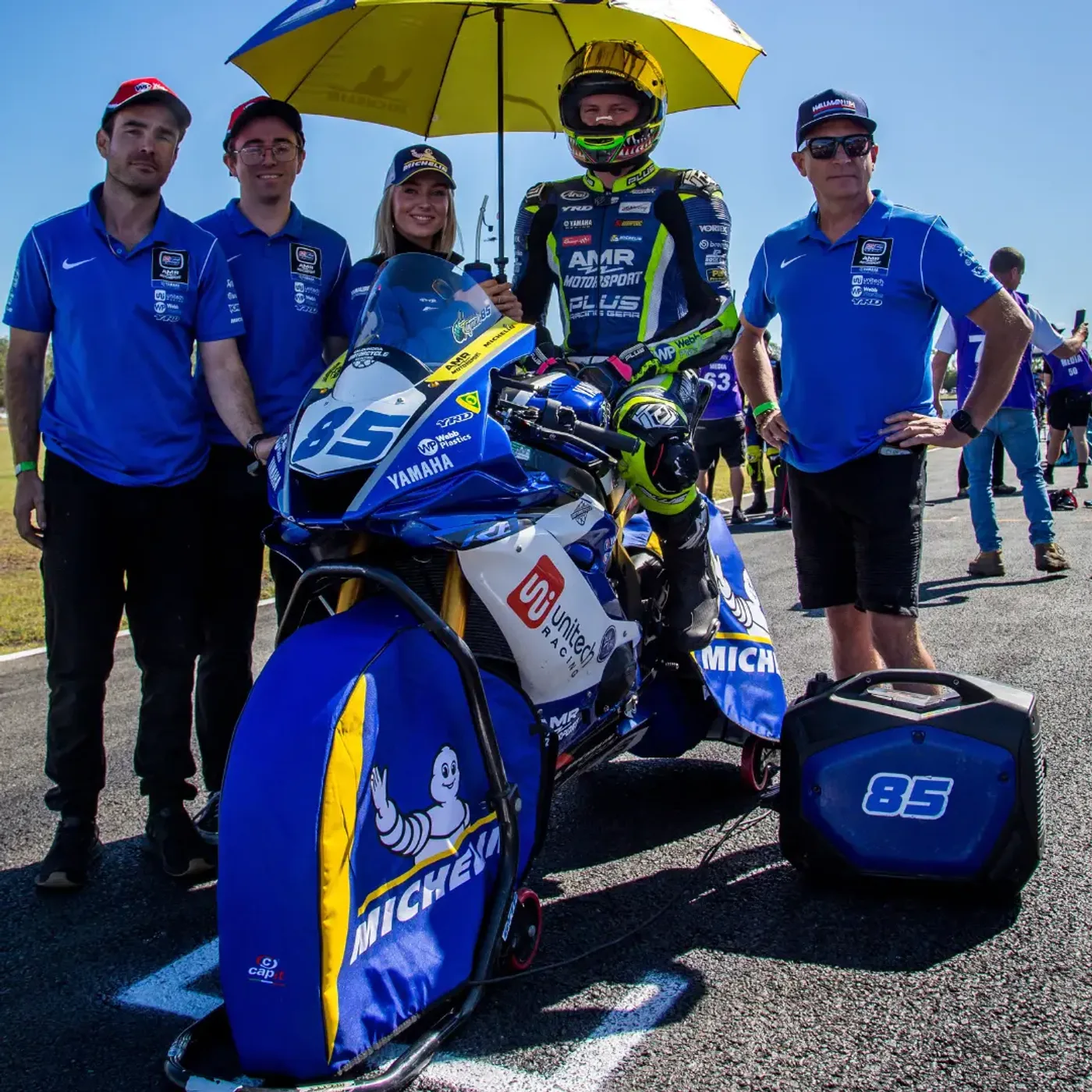 The Slipstream Autosport crew and rider in pit lane beside the race bike